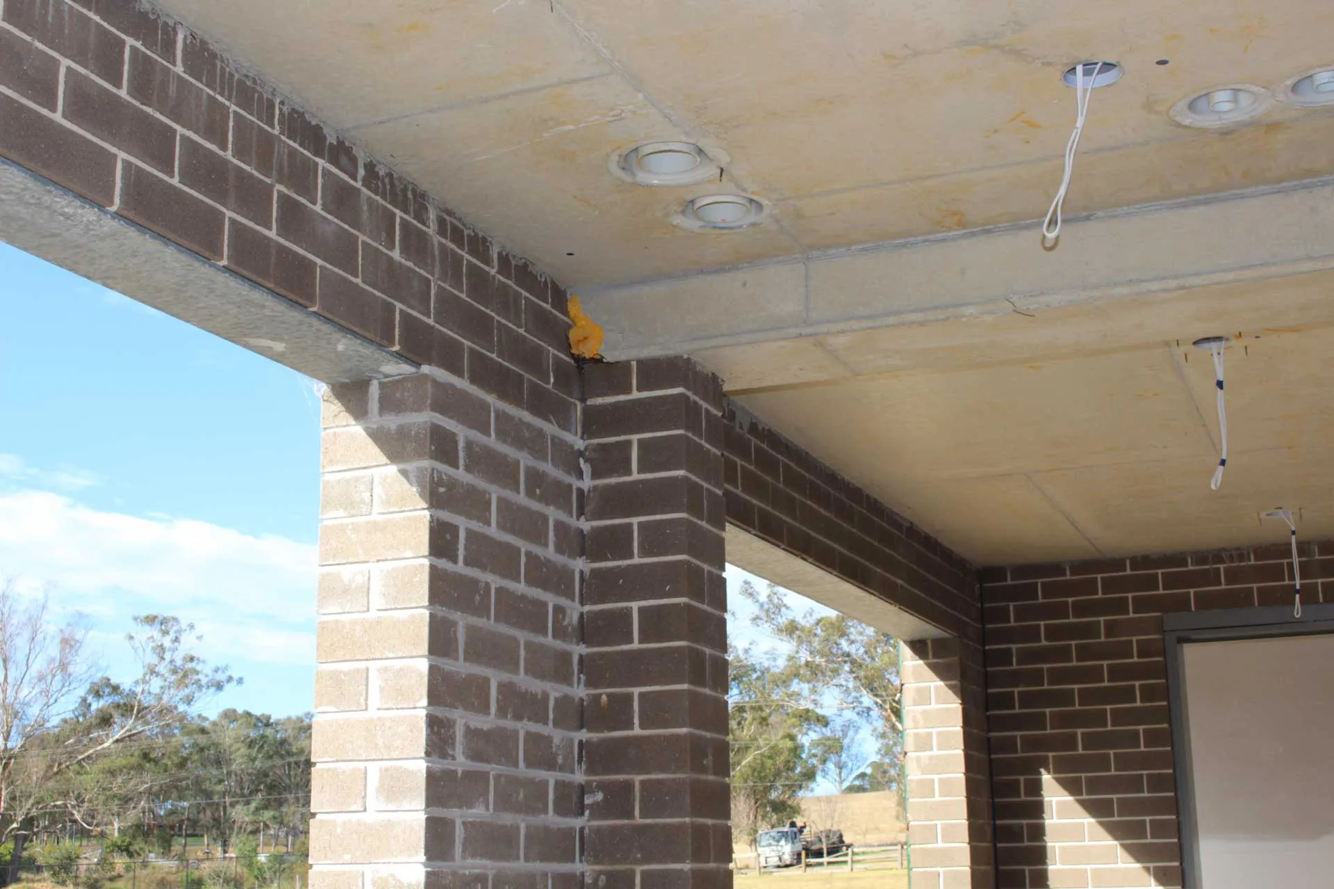 Using a structural system of brick columns and reinforced concrete beams to provide load bearing support